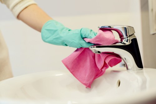Cleaner preparing a safe workspace before starting a cleaning task