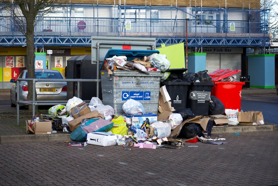 A sanitation truck parked on a residential street, associated with Cleaners Knightsbridge, features a white body with the number 610 and the label 'O’DREAN.' The truck is filled with various waste m